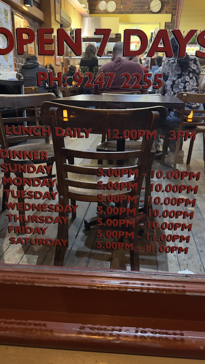 Zia Pina Pizzeria front window with opening hours